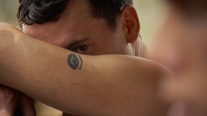 Adam peeks at another man in Of an Age.