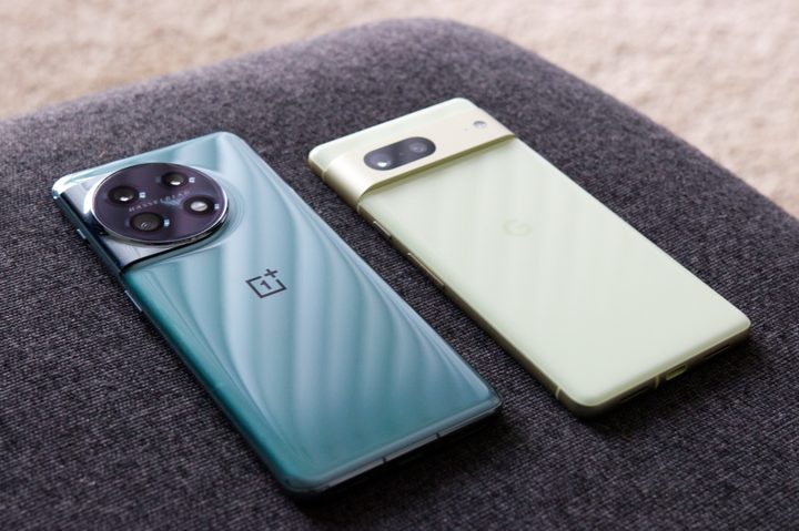 OnePlus 11 and Google Pixel 7 lying next to each other on a couch.