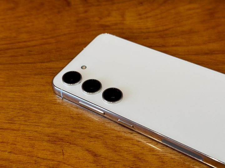 Samsung Galaxy S23 camera closeup on glossy wooden table