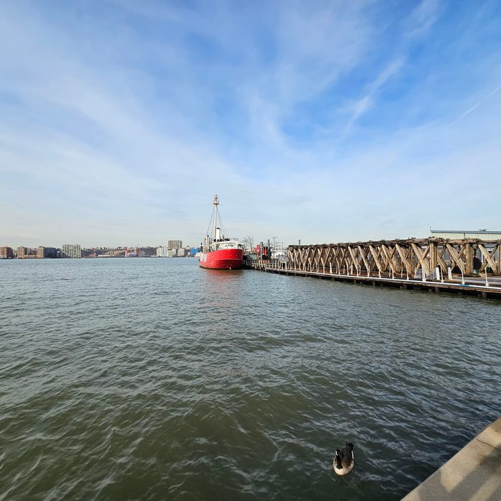 Wide-angle photo from the Galaxy S23 Ultra, showing a red boat by a dock on the water.