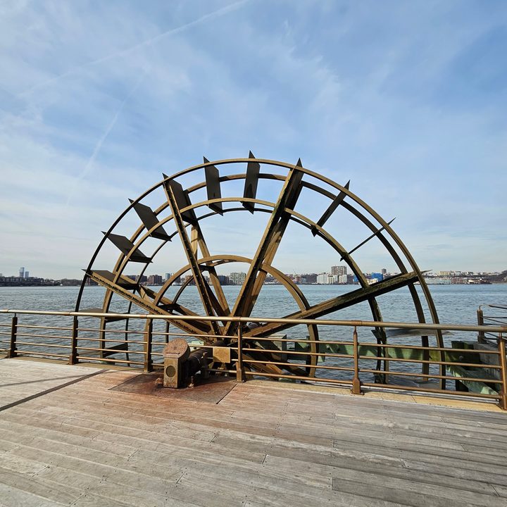 Wide-angle photo from the Galaxy S23 Ultra, showing a large wheel by a dock.