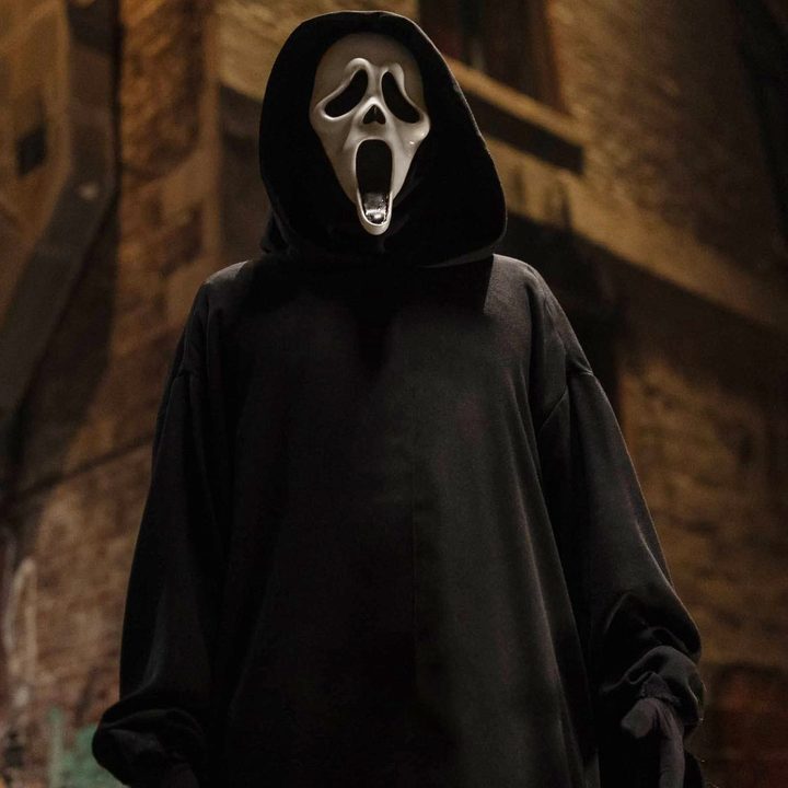 Ghostface stands in a street in Scream VI.