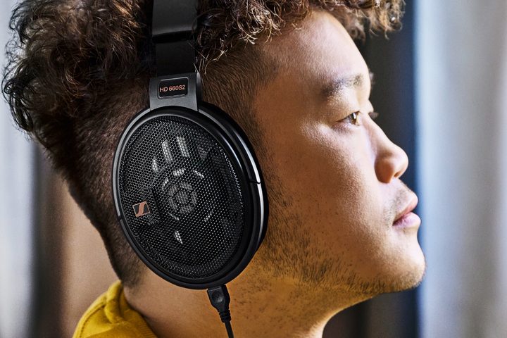 Man wearing Sennheiser HD 660S2 open-back headphones.
