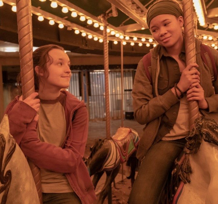 Two girls ride a merry-go-round in The Last of Us.