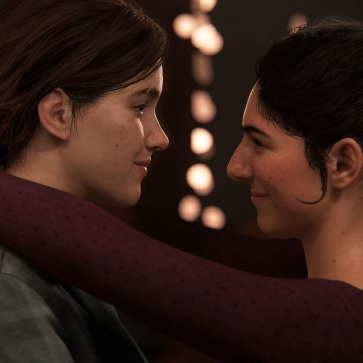 A screenshot from The Last of Us Part 2 of Ellie and Dina slow dancing with one another.