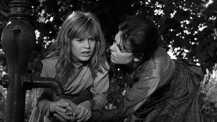 Patty Duke in The Miracle Worker, faced ahead with a woman comforting her.