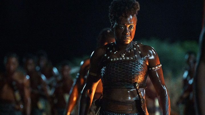 Viola Davis in battle gear, leading an army in a scene from The Woman King.