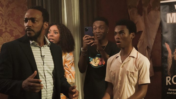 The family of characters in We Have A Ghost stares in disbelief.