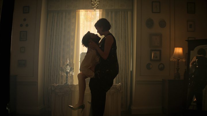 Joe lifting Kate in the air as she straddles him in a scene from You season 4.