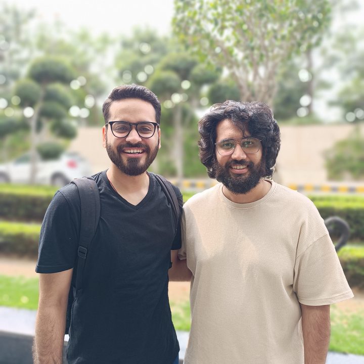 Two men standing in a hotel driveway captured by Redmi Note 12 Pro Plus.