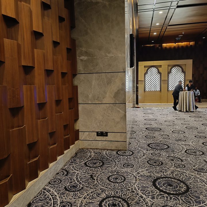 A dim lit hotel hallway captured by Redmi Note 12 Pro Plus.