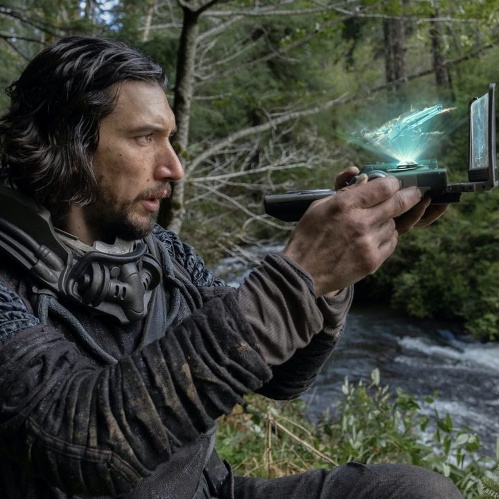 Adam Driver holds a futuristic scanner in 65.