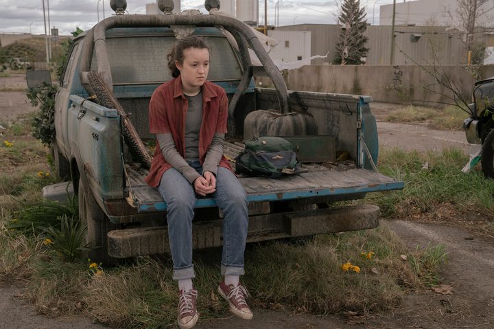 Ellie sits on a truck bed in The Last of Us Episode 9.