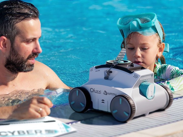 Father and daughter near Ofuzzi Cyber 1200 robotic pool vacuum with manual.