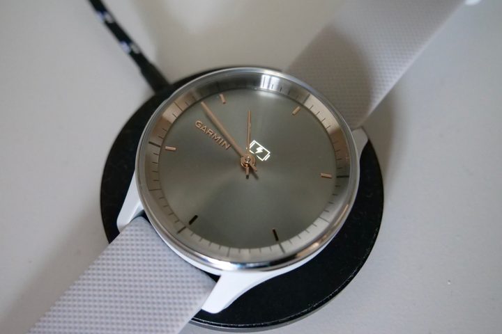 The Garmin Vivomove Trend connected to a wireless charger.