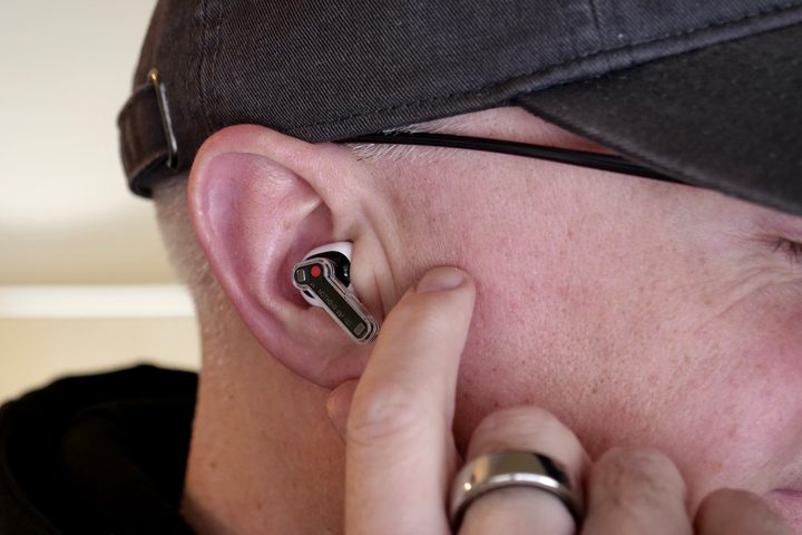 A person wearing the Nothing Ear 2 earbuds.