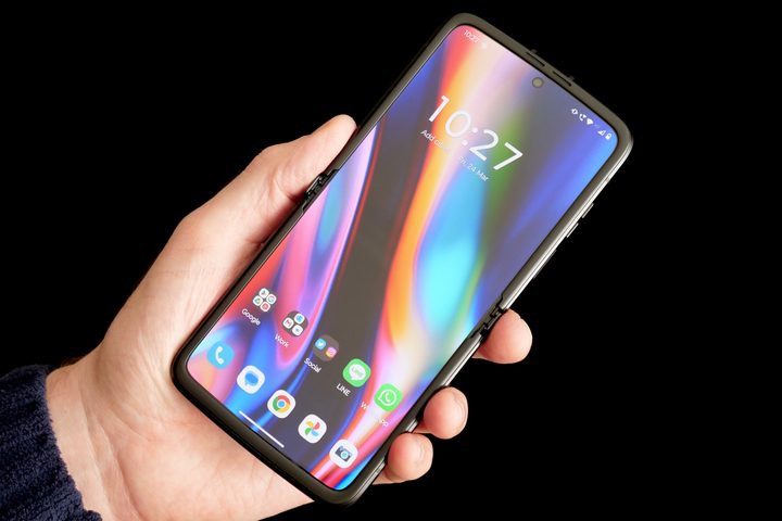A person holding the Motorola Moto Razr (2022), showing the screen.