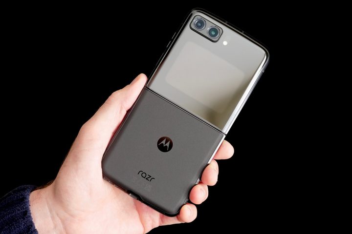 A person holding the open Motorola Moto Razr (2022), seen from the back.