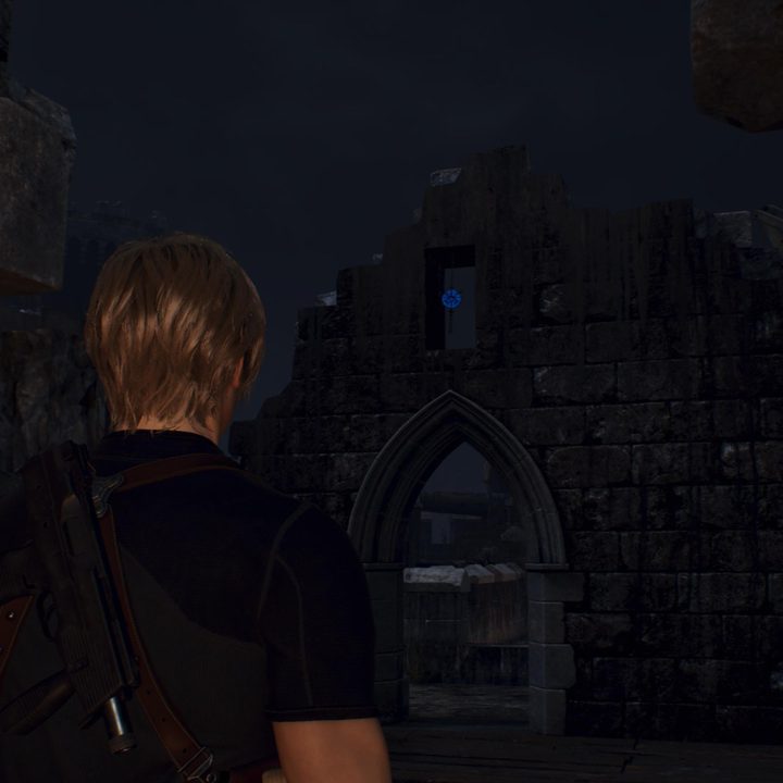 Leon looks at a blue medallion