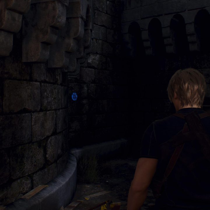 Leon looks at a blue medallion
