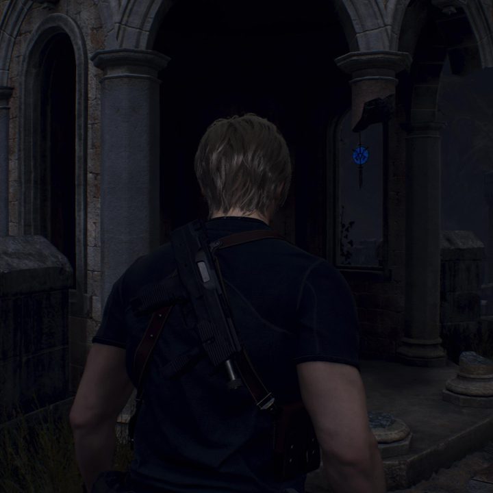Leon looks at a blue medallion