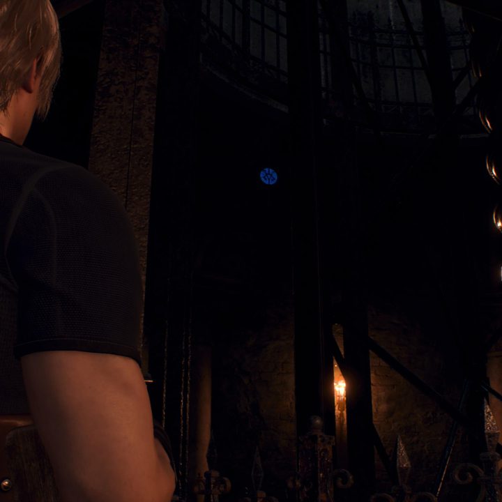 Leon looks at a blue medallion