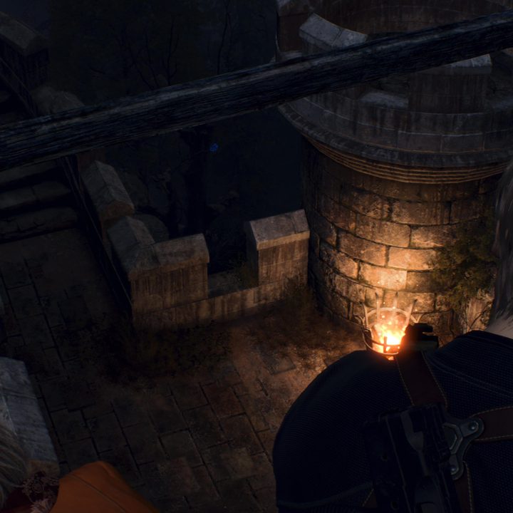 Leon looks at a blue medallion