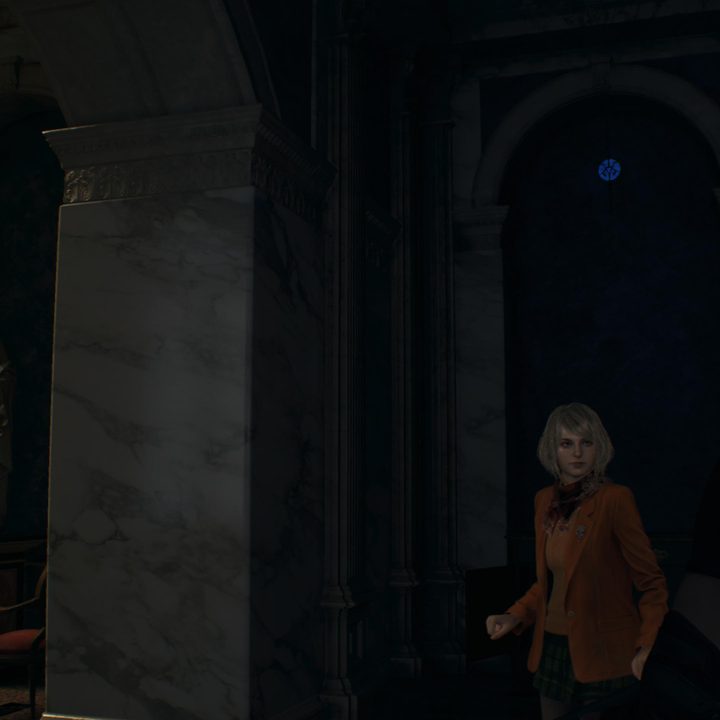 Leon looks at a blue medallion