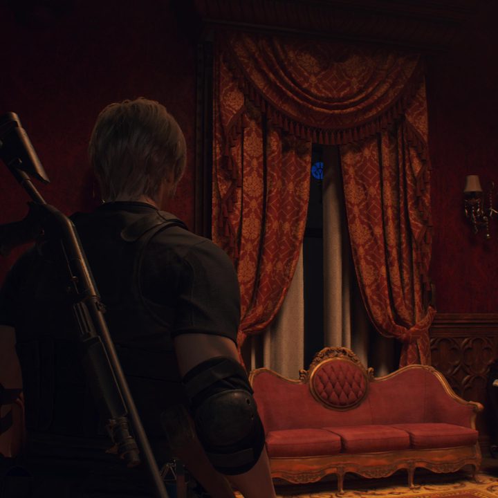 Leon looks at a blue medallion
