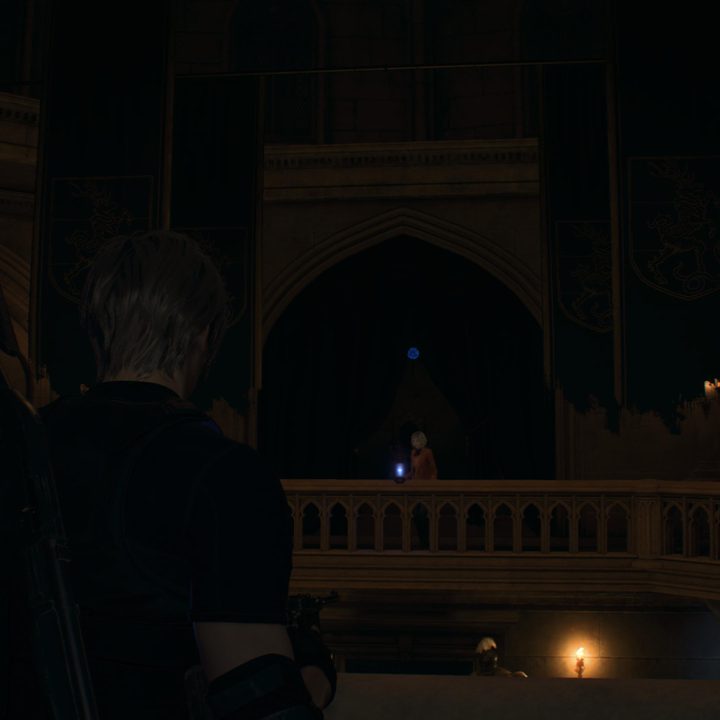 Leon looks at a blue medallion