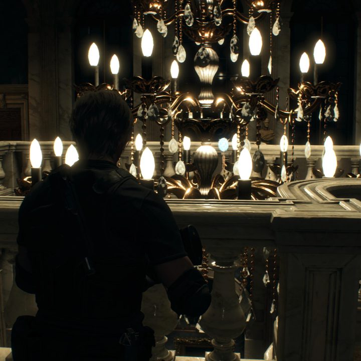 Leon looks at a blue medallion
