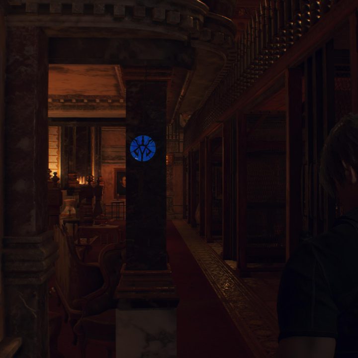 Leon looks at a blue medallion