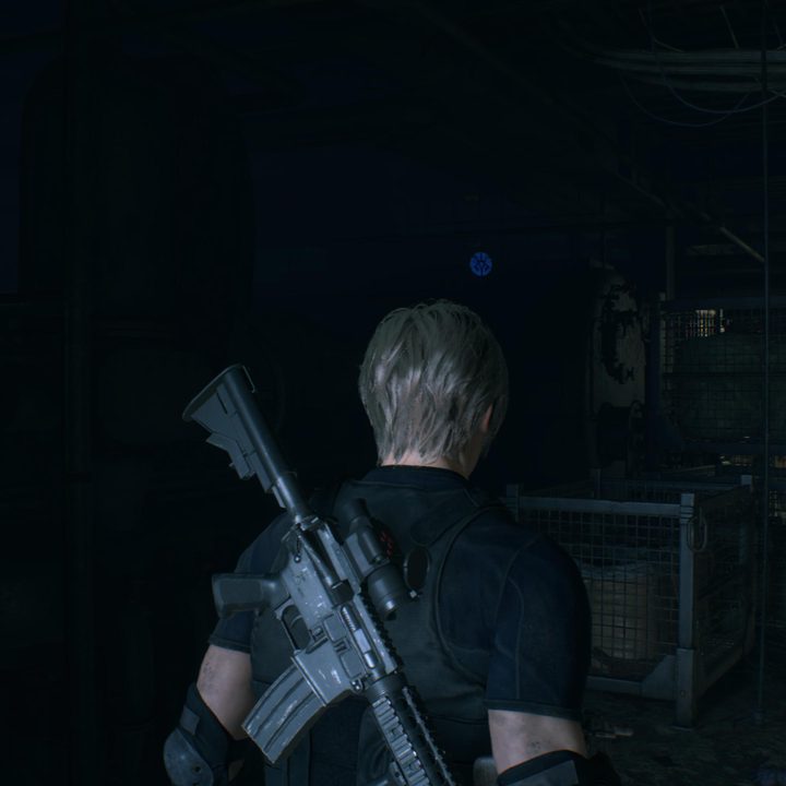 Leon looks at a blue medallion
