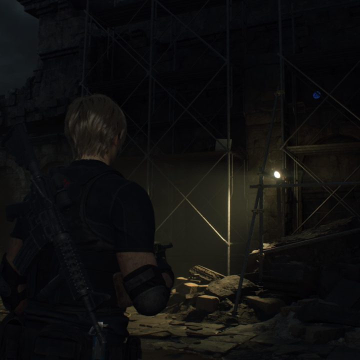 Leon looks at a blue medallion