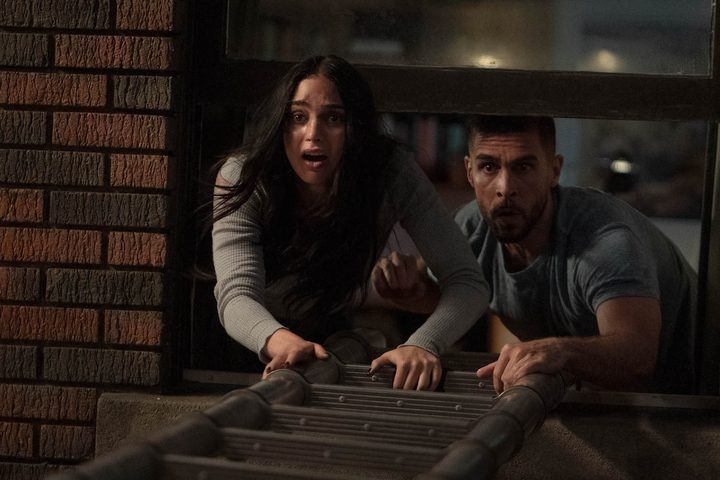 Sam and her boyfriend hold out a ladder for their friends.