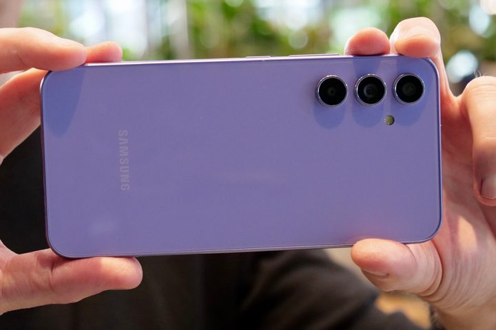 A person holding the Galaxy A43 phone and taking a photo.