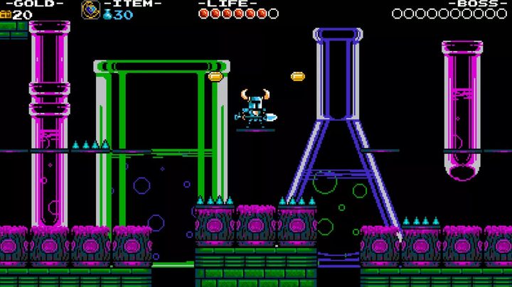 Shovel Knight stands in front of colorful beakers.