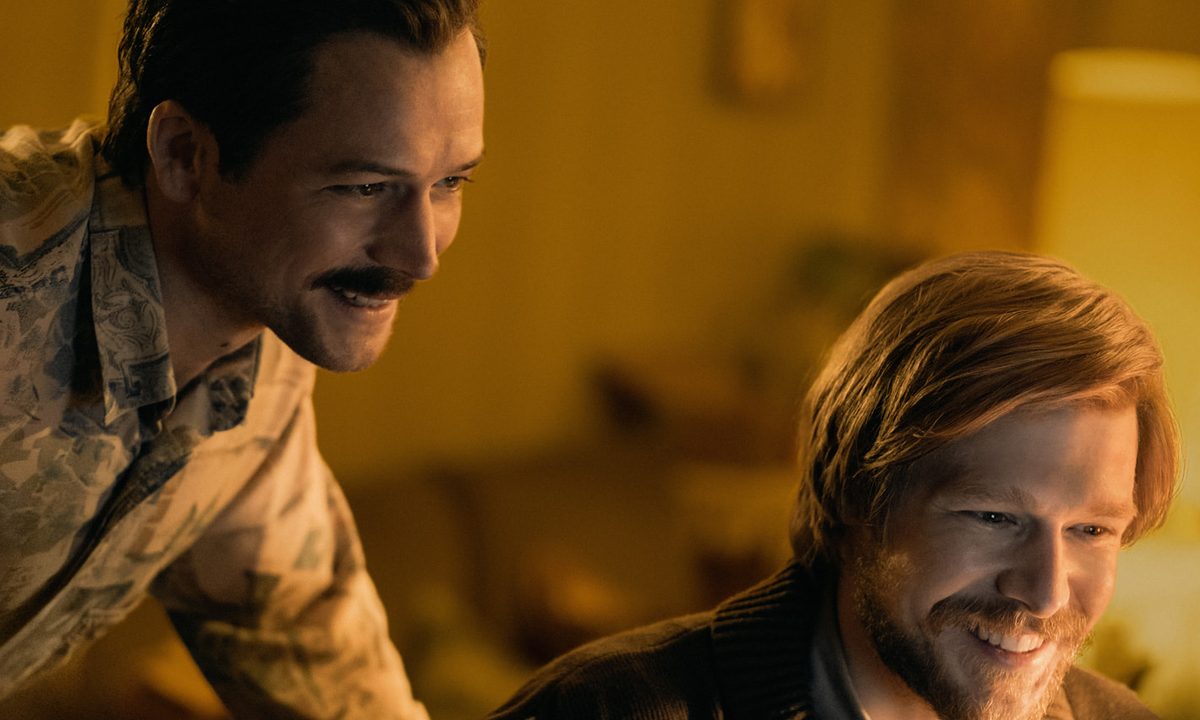 Taron Egerton and Nikita Yefremov smile together in Tetris.