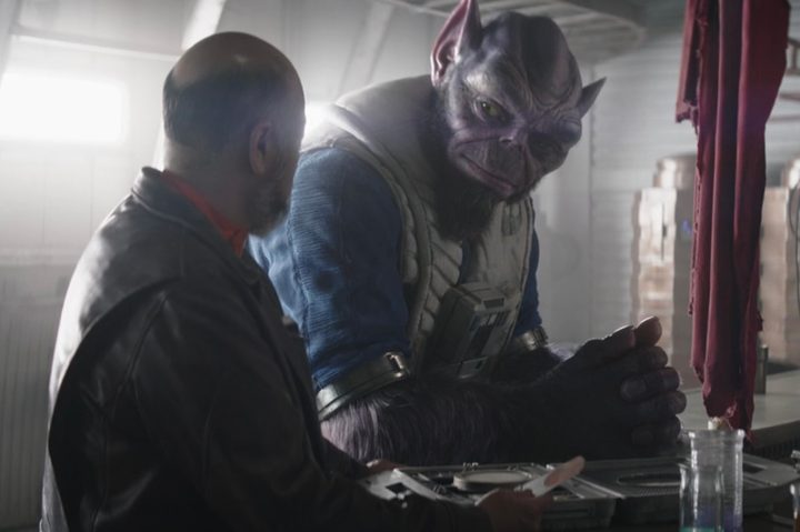 Zeb stands at a bar with Carson Teva in The Mandalorian season 3 episode 5.