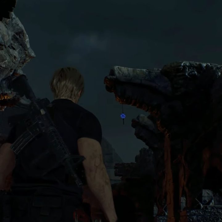 Leon looks at a blue medallion