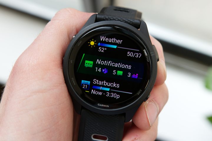 Someone holding the Garmin Forerunner 265.