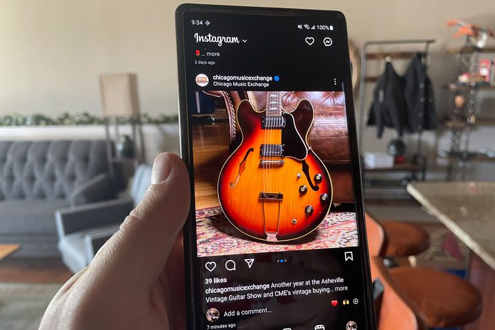 A Galaxy S23 Ultra running Instagram. On the screen, there's an orange guitar.