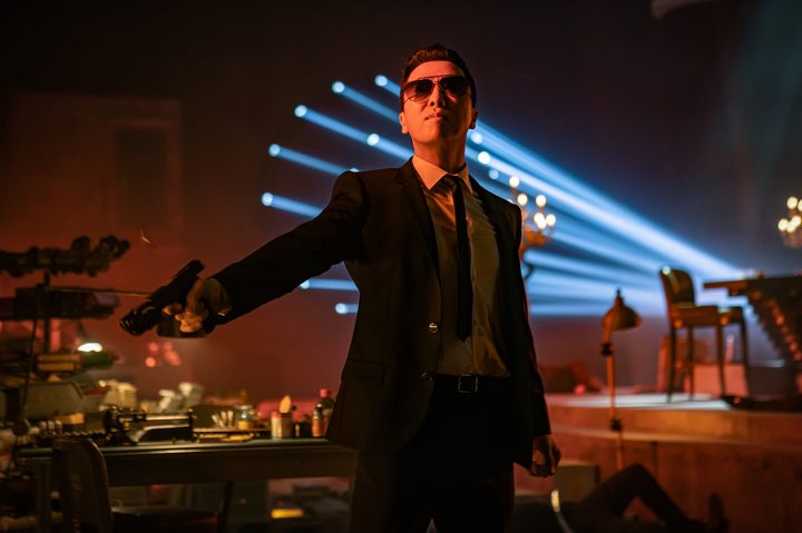 A man stands and points a gun in "John Wick: Chapter 4."