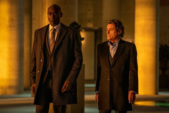 Two men stand next to each other and walk in "John Wick: Chapter 4."