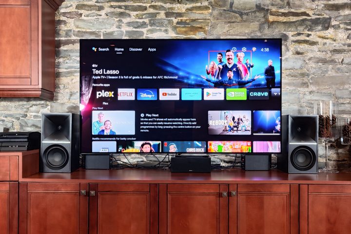 Klipsch The Sevens beside a TV, grilles removed.