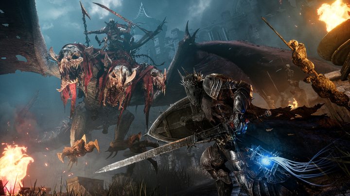 A knight with a large sword prepares to stab a dragon in Lords of the Fallen.