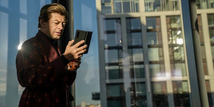 A man stands by a window in Luther: The Fallen Sun.