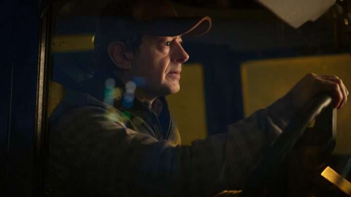 A man waits in a car in Luther: The Fallen Sun.