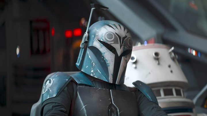 A bounty hunter sits in The Mandalorian.