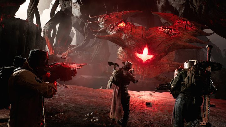 Three characters shoot at a boss in Remnant 2.